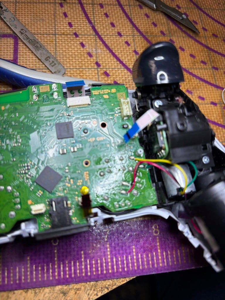 Disassembled DualSense controller showing internal board and wiring