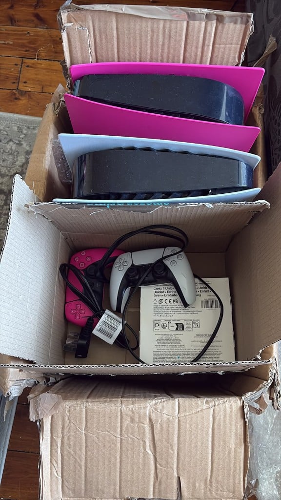 PlayStation 5 consoles and DualSense controllers packed for repair