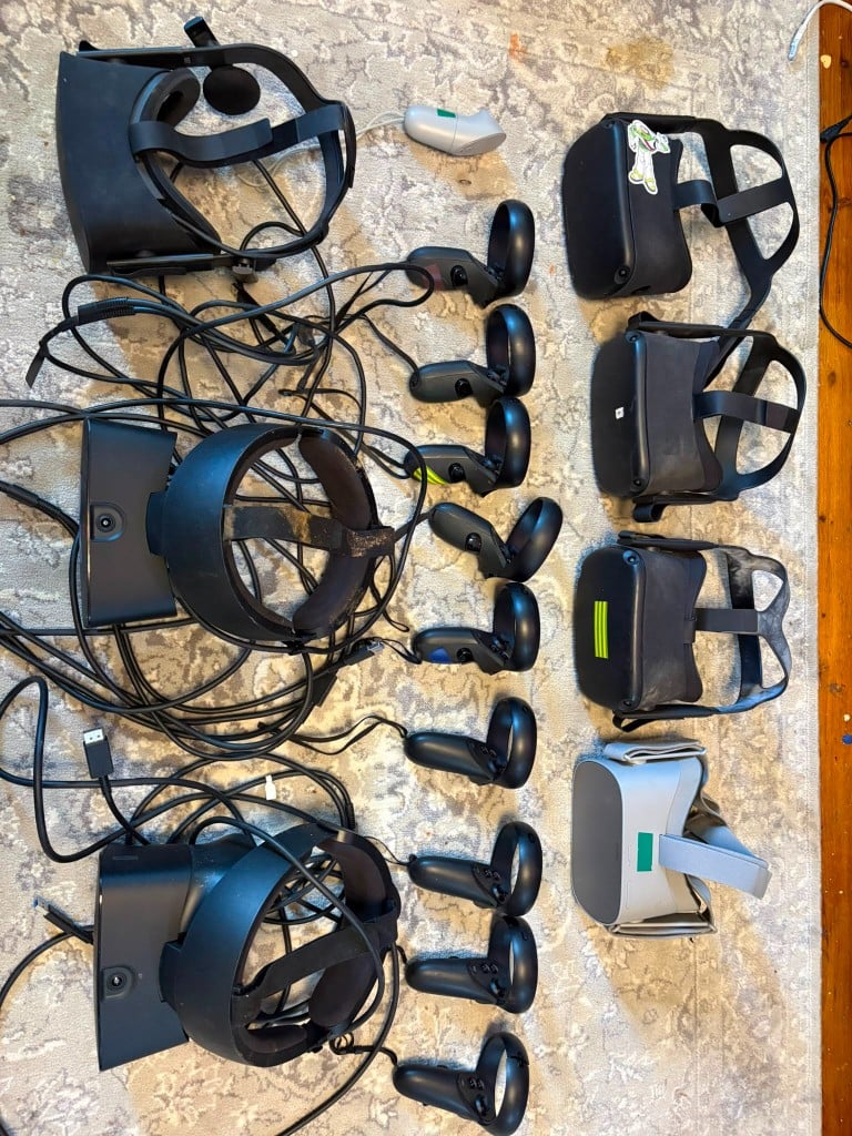 VR headsets and motion controllers laid out for repair